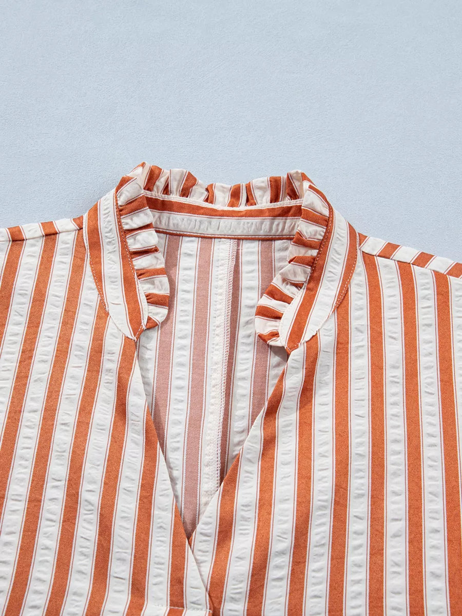 Striped V-neck mini dress with ruffled collar and textured fabric.