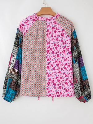 Boho patchwork blouse in fuchsia pink with floral and geometric prints, drop shoulder, and bubble sleeves.