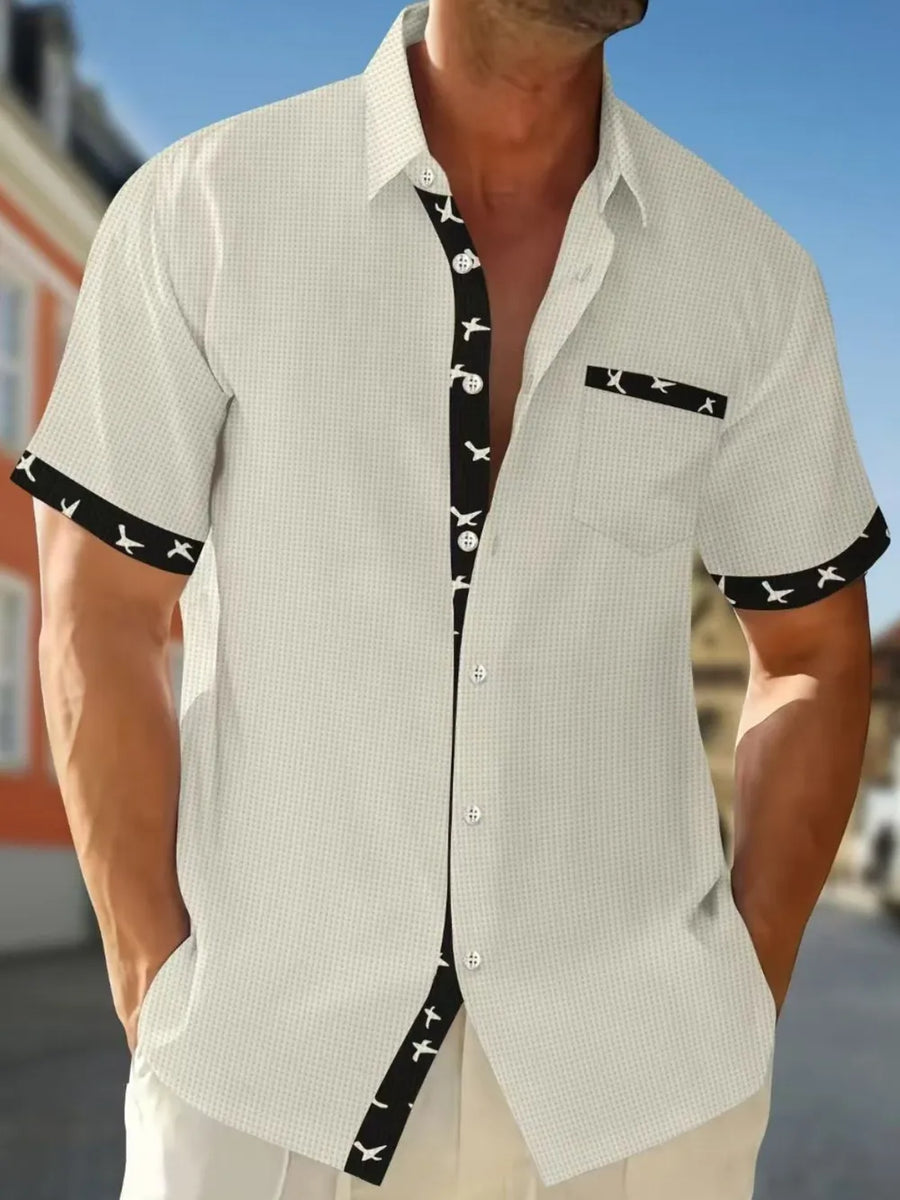 White waffle weave short sleeve shirt with airplane print contrast trim and pocket.