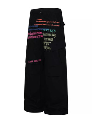 Black cargo pants with colorful text print and multiple pockets.
