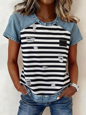 Denim patchwork blouse with black and white stripes, distressed details, and a square chest pocket.
