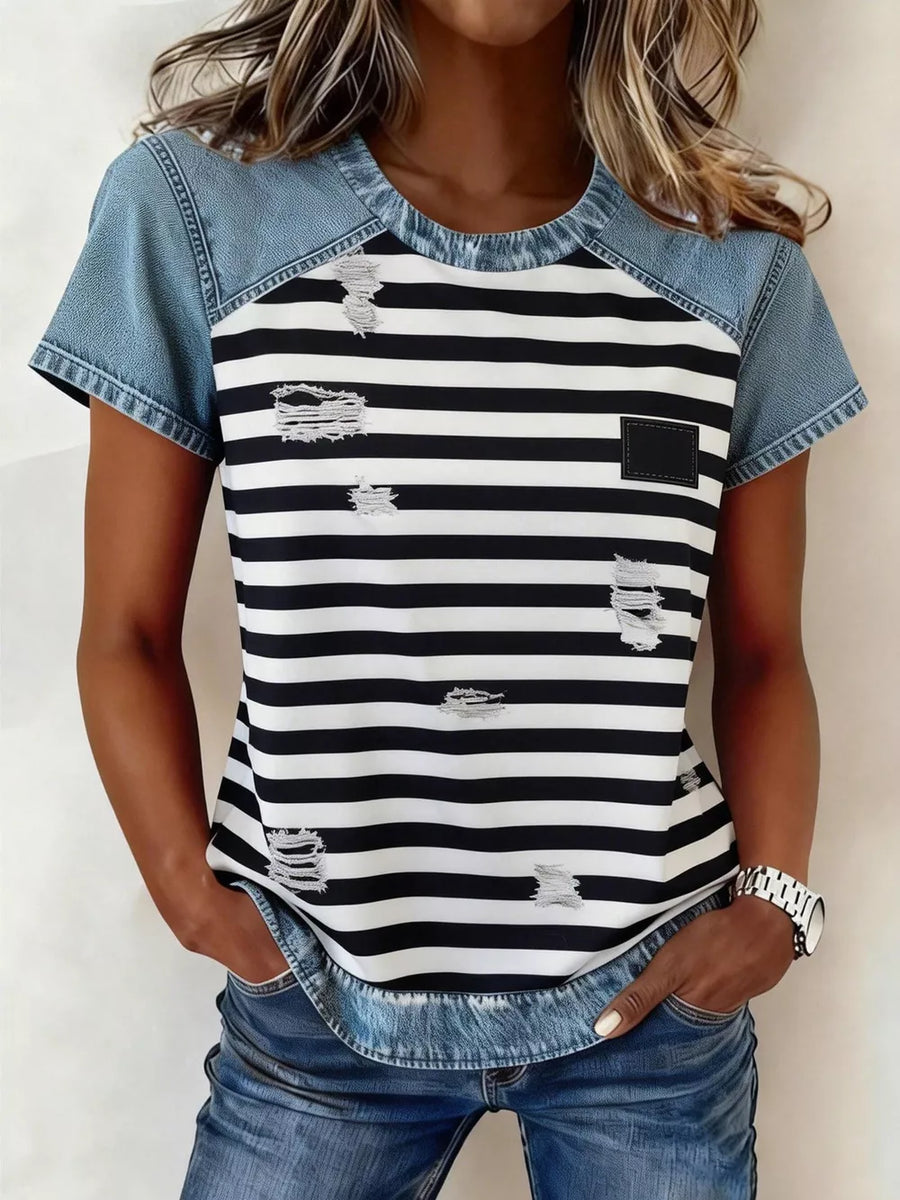 Denim patchwork blouse with black and white stripes, distressed details, and a square chest pocket.
