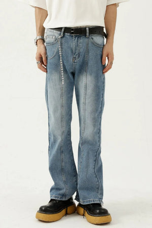 Medium wash denim flare jeans with seam detail and chain accessory