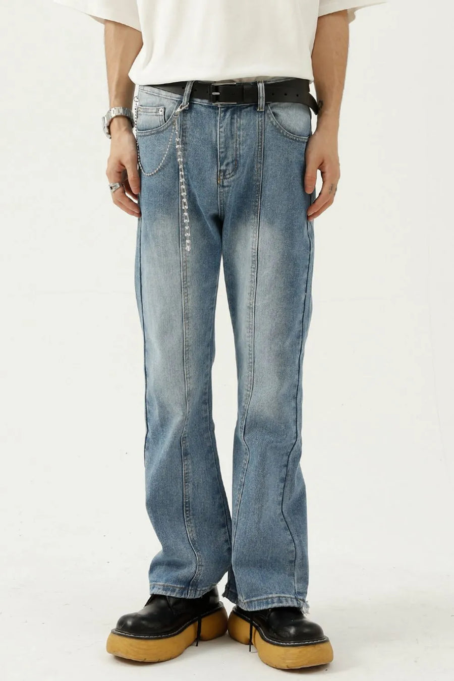 Medium wash denim flare jeans with seam detail and chain accessory