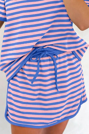 Relaxed two-piece set with pink and blue stripes, crew neck top, and drawstring shorts.