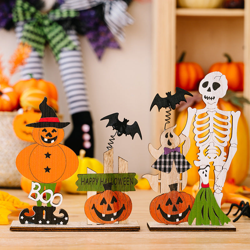 Spooky wooden Halloween scene set with pumpkin figures, ghost, skeleton, and bats.