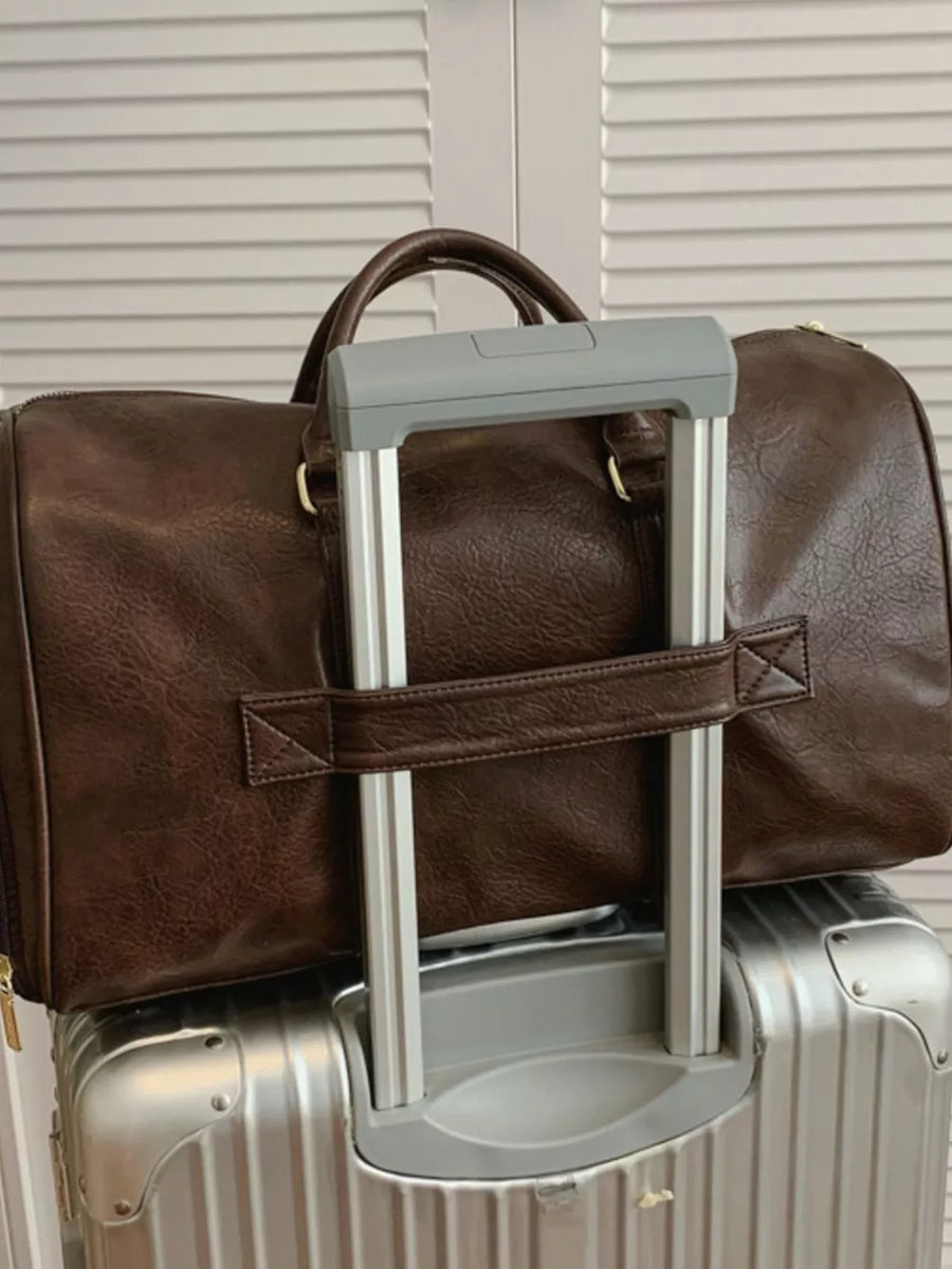 Brown faux leather travel organizer bag with top handles and a detachable strap.
