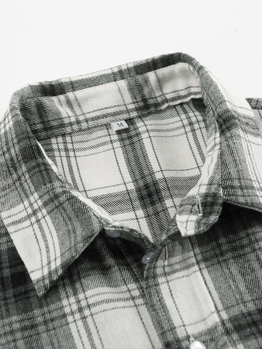 Button-up long sleeve shirt in black and white plaid cotton with a classic collar.