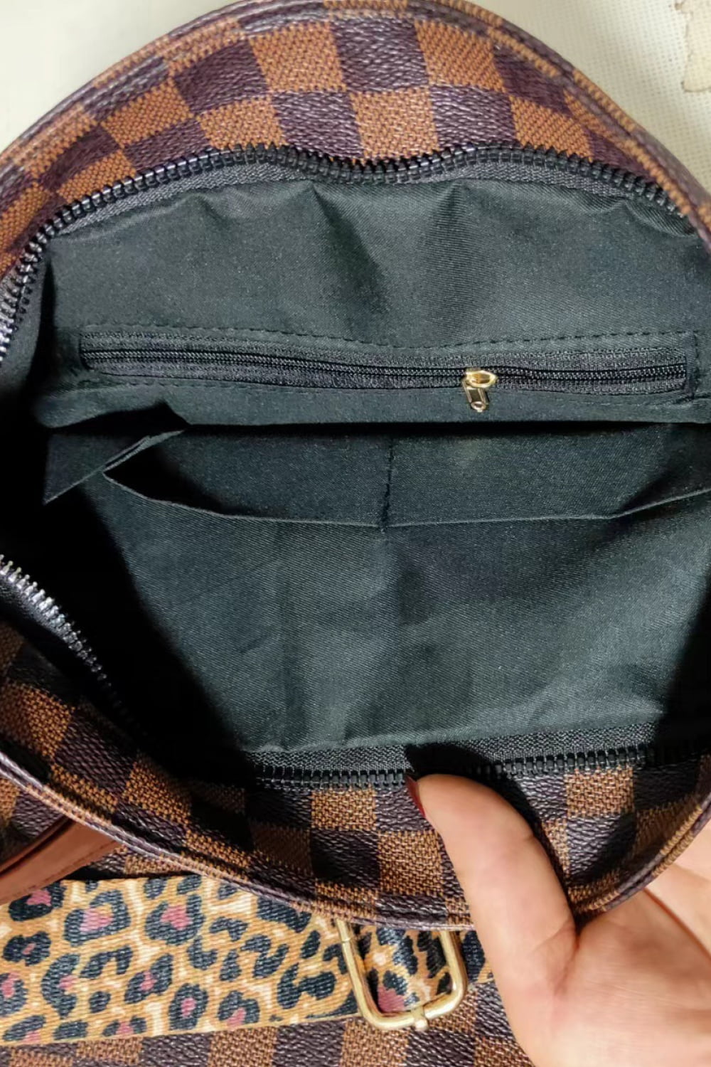Chocolate embossed crossbody bag interior with leopard print strap detail.