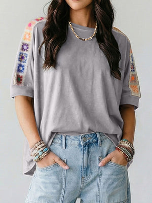 Grey t-shirt with colorful crochet detail on sleeves, loose fit, casual style.