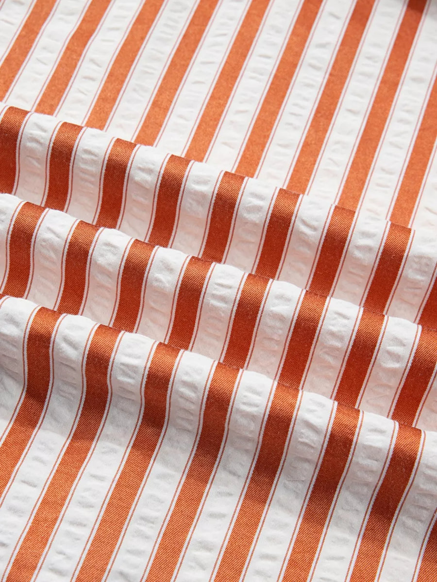Striped V-neck mini dress in orange and white seersucker fabric