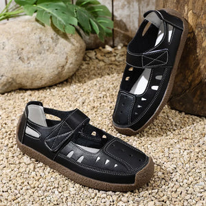 Black round toe platform shoes with cutouts and white stitching.