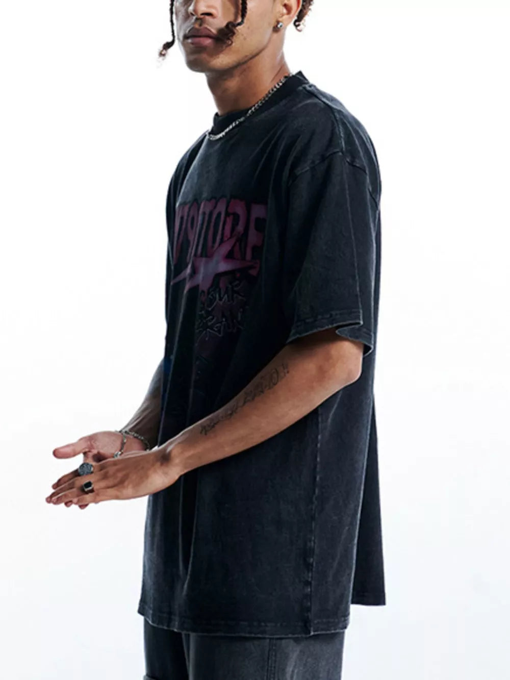 Black oversized graphic tee with crew neck and short sleeves, featuring a vintage wash and cosmic print.