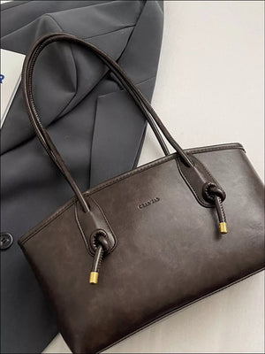 Brown leather shoulder bag with knotted strap details and gold accents.