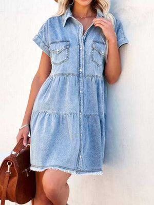 Light blue tiered denim shirt dress with frayed hem and short sleeves.