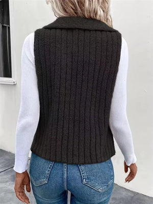 Cozy open front fleece vest in dark gray with vertical ribbing, styled over a white long-sleeve shirt.