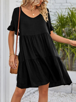 Black tiered mini dress with ruffled sleeves and V-neckline.