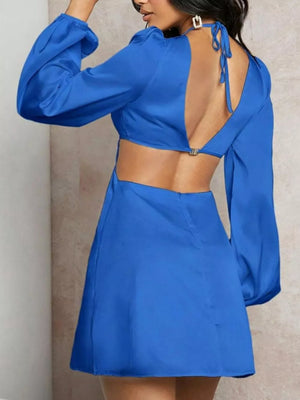 Blue cutout mini dress with long cuffed sleeves and criss-cross back detail.