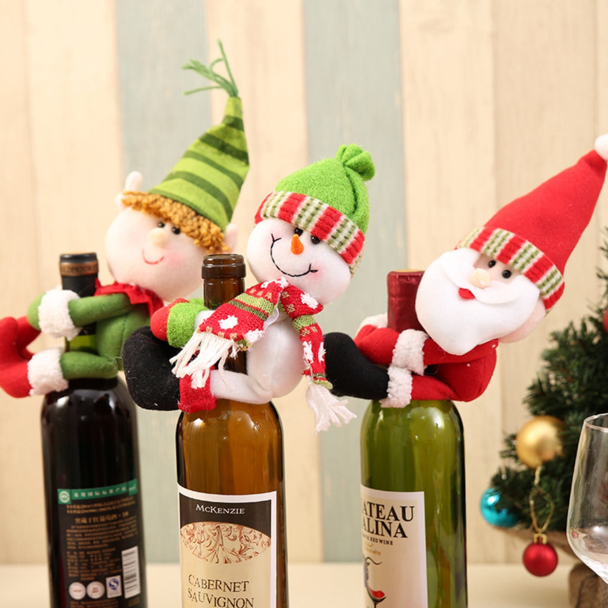 Holiday bottle toppers featuring Santa, snowman, and elf designs in festive colors.