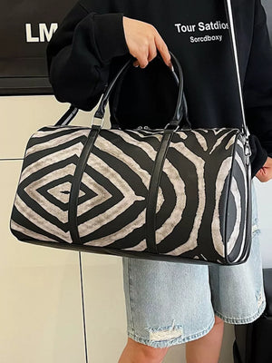 Large black and white zebra print duffle bag with carry handles and a detachable strap.