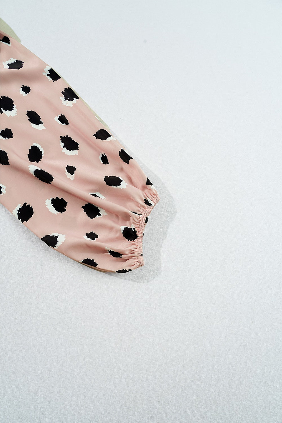 Blouson sleeve blouse in dust storm pink with black spot print and elastic cuff.