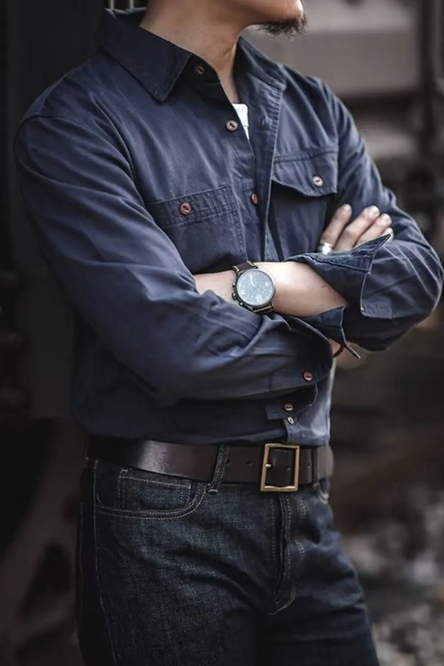 Navy cotton twill utility shirt with button-flap chest pockets and rolled sleeves.