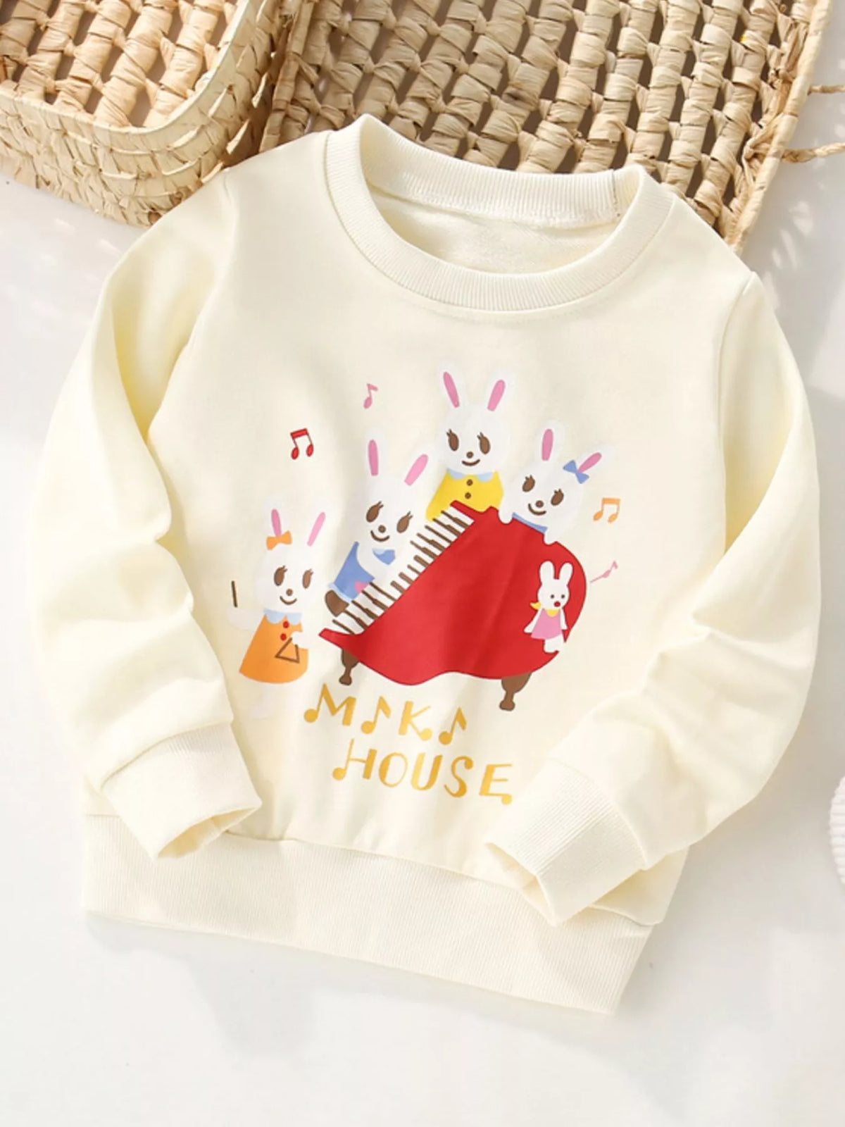 Ivory cotton crew neck sweatshirt with a cute rabbit piano band graphic and "Maka House" text.