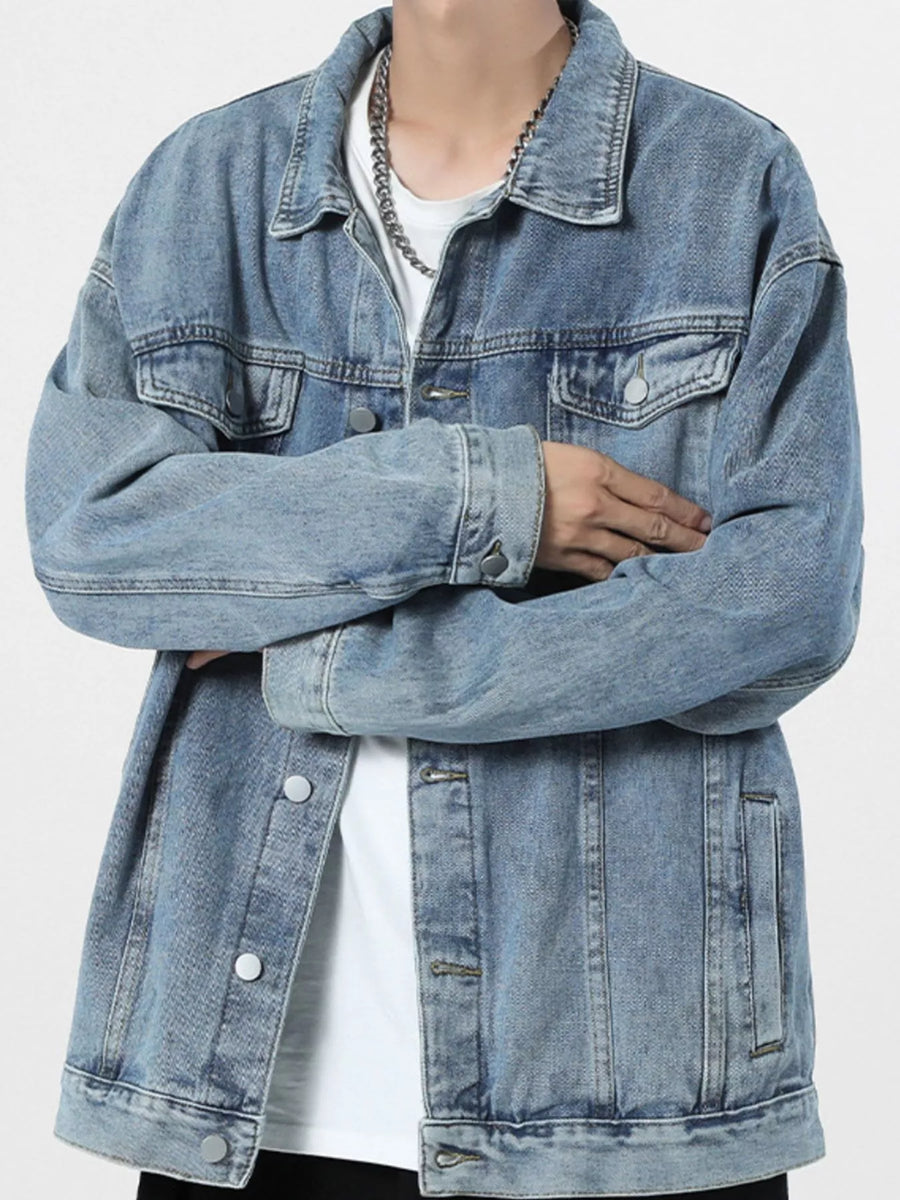Light blue 100% cotton denim trucker jacket with button-up front and chest pockets.