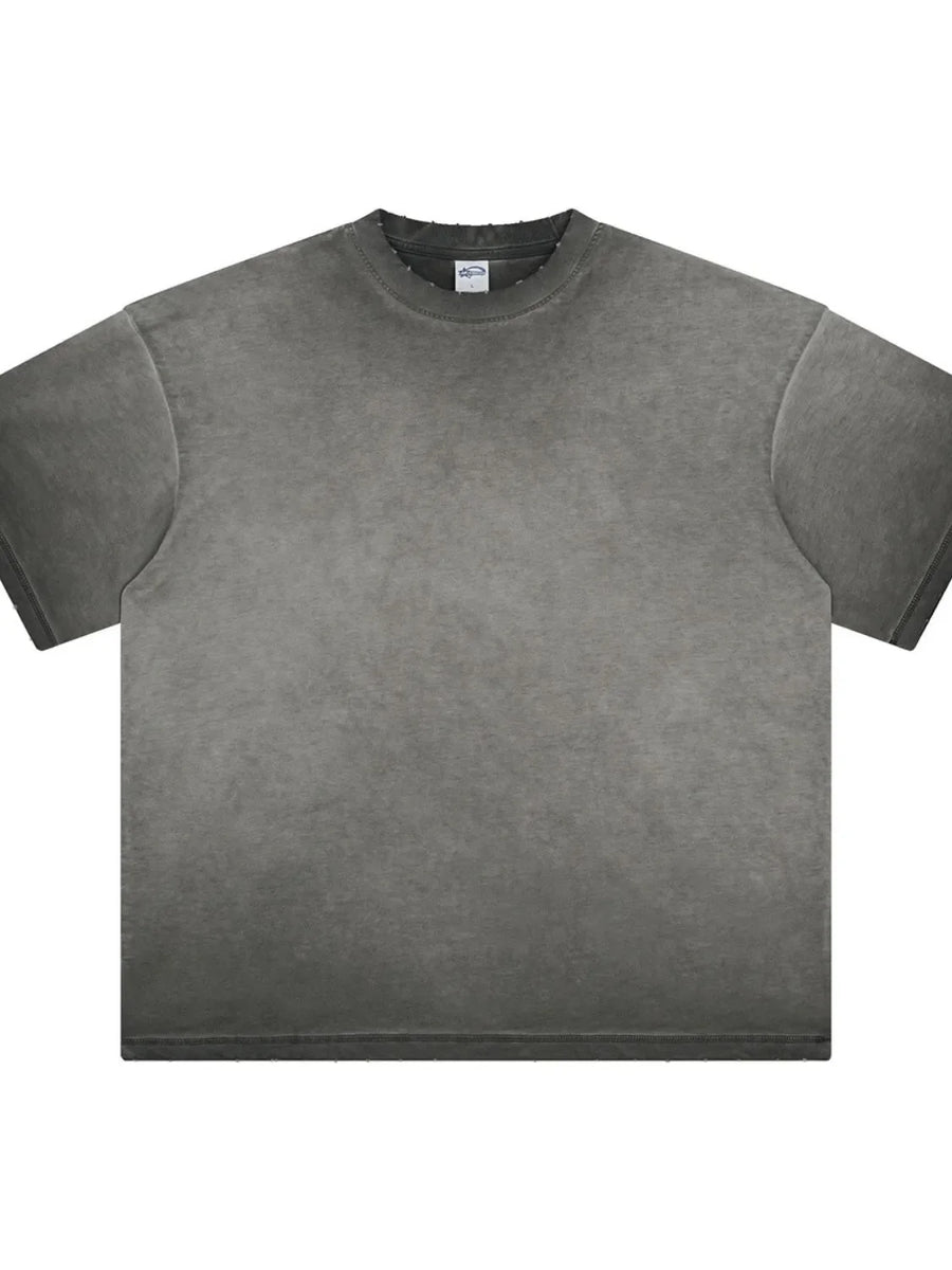 Washed black oversized t-shirt with distressed neckline and raw hem.