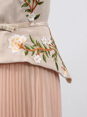 Embroidered midi dress with floral detail and pleated tulle skirt.