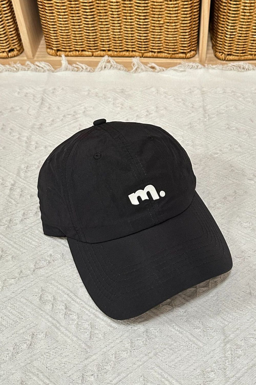 Black baseball cap with white embroidered m
