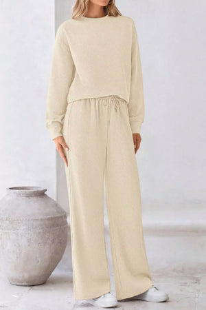 Cozy drawstring lounge set in apricot with a textured pattern and wide-leg pants.
