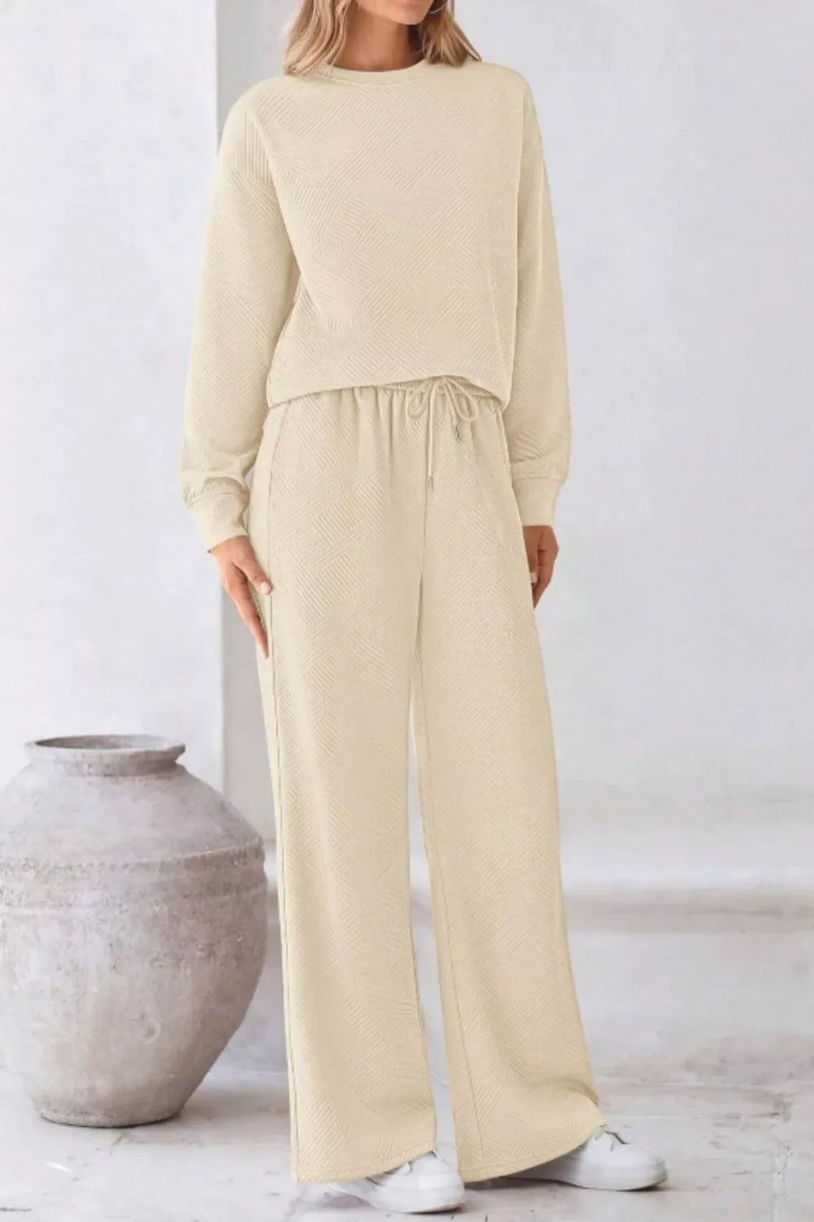 Cozy drawstring lounge set in apricot with a textured pattern and wide-leg pants.