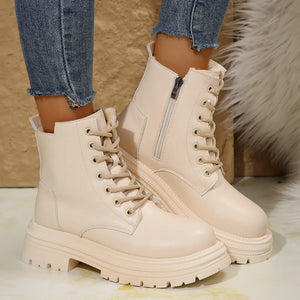 Beige combat boots with side zip detail and lace-up front.