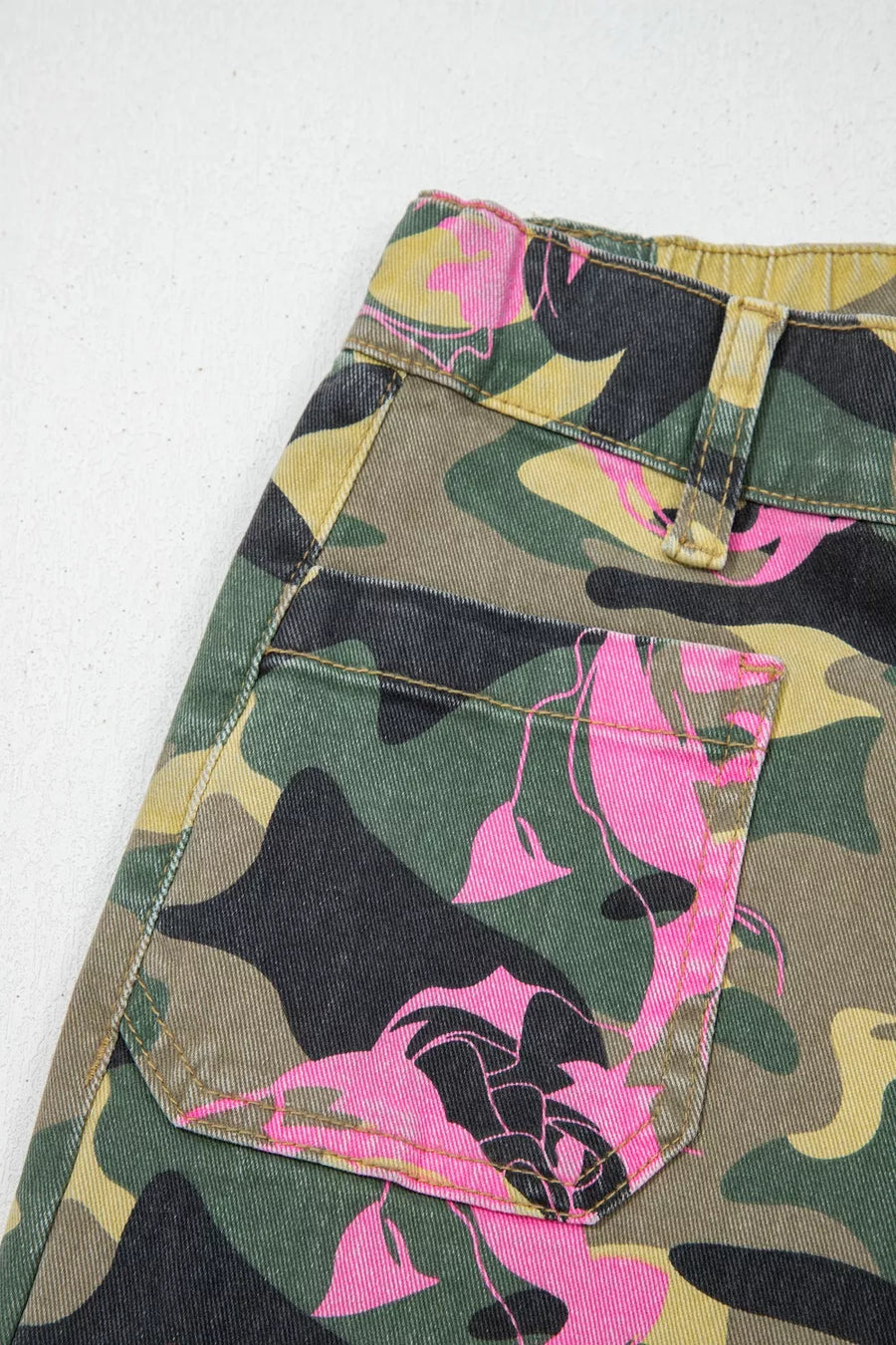 Contrast patchwork floral and leopard print denim jeans with pink floral accents on camouflage.
