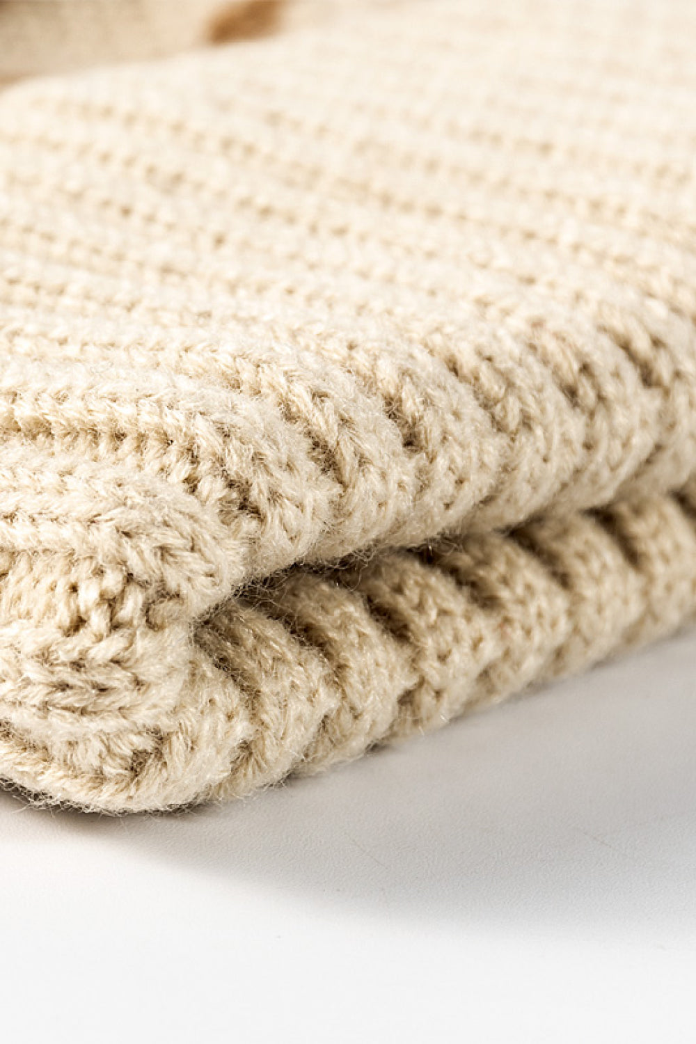 Beige acrylic beanie with textured knit pattern and folded brim