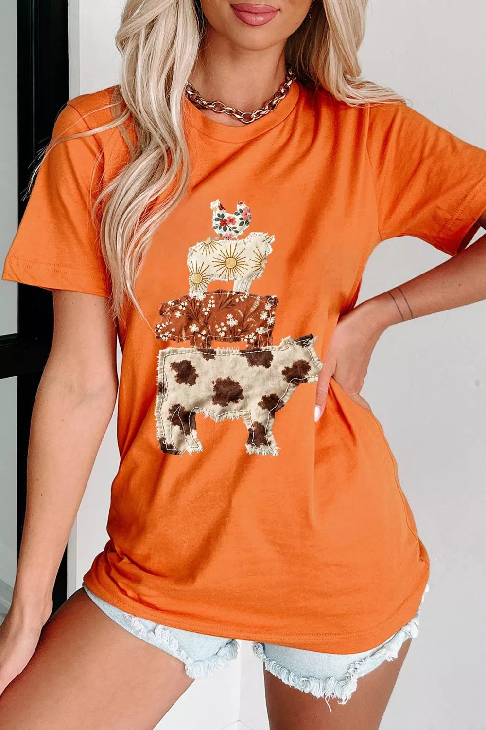 Orange graphic tee with stacked farm animal applique, short sleeves, crew neck.