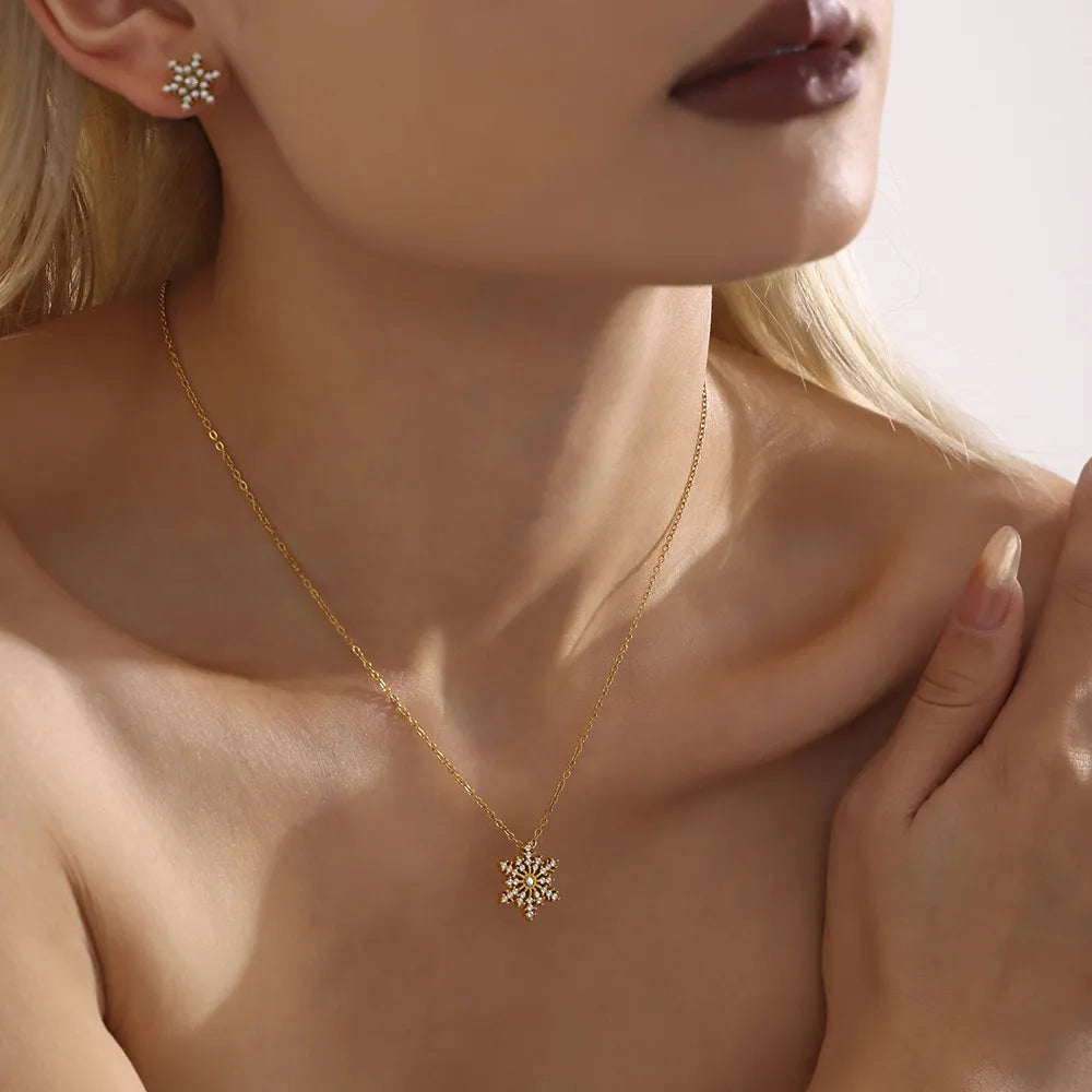 Celestial Snowflake Pendant Necklace with gold chain and matching earrings.