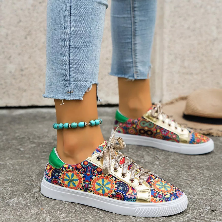 Mandala print round toe sneakers with gold accents and green heel tabs.