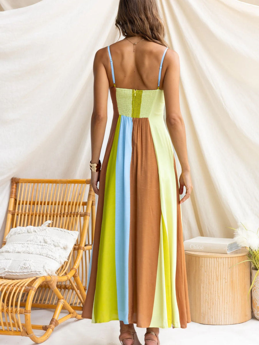 Maxi dress with smocked bodice and color block skirt in blue, brown, and lime green.