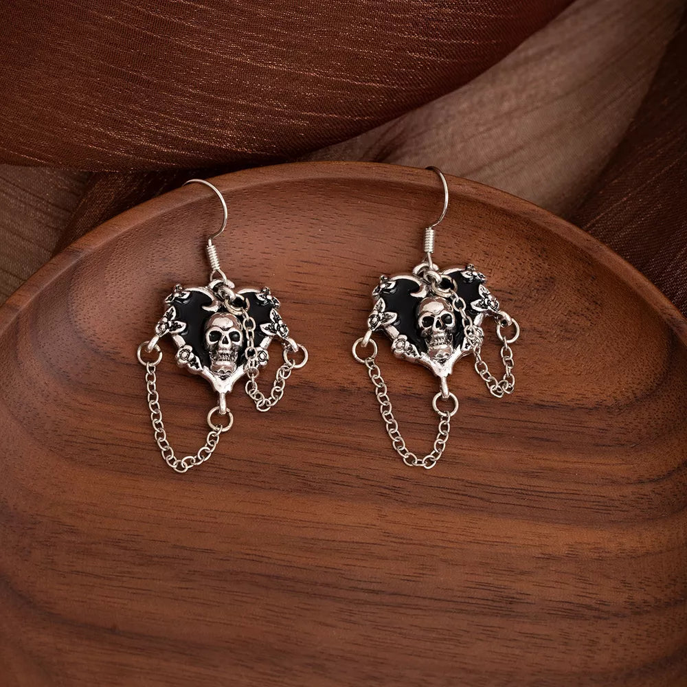 black earrings featuring skull motif and skull motif