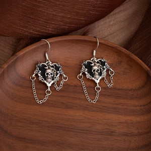 black earrings featuring skull motif and skull motif