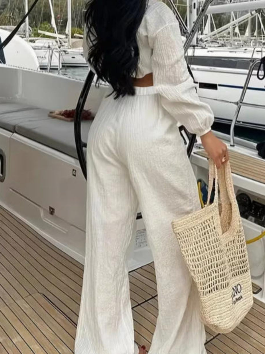 White textured tie-front crop top and wide-leg pants set with balloon sleeves.