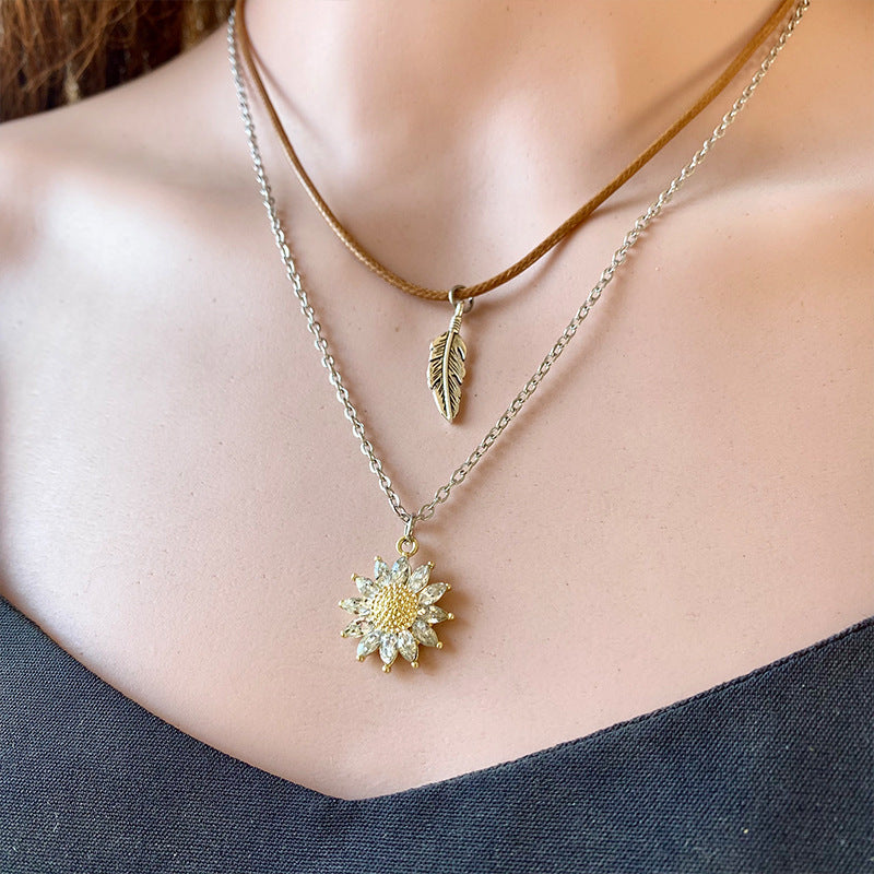 Layered necklace set with sunflower and feather charms, gold and silver alloy.