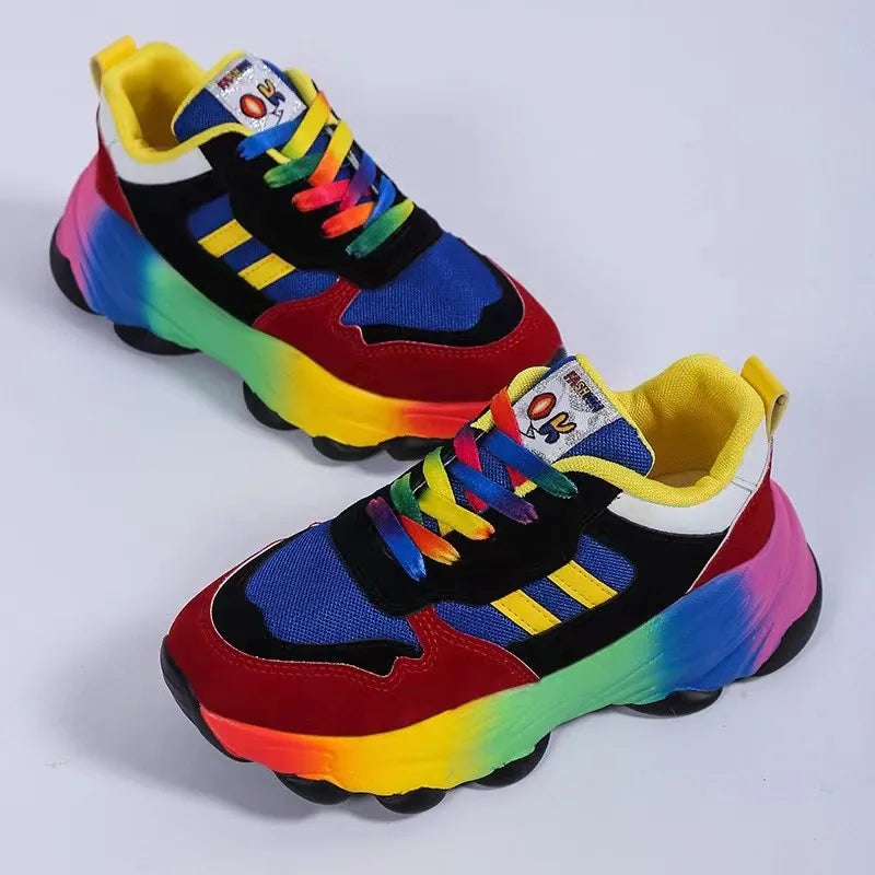 Rainbow gradient chunky sneakers with blue, red, black, and yellow accents.