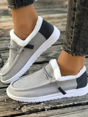 Gray corduroy slip-on sneakers with white sherpa lining and dark gray heel detail.