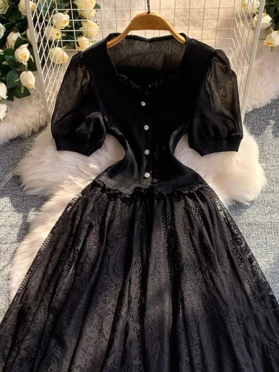 Black lace-embellished puff sleeve dress with button front and ruffled neckline.