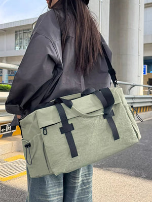 Spacious olive green duffel bag with black straps and adjustable shoulder strap.