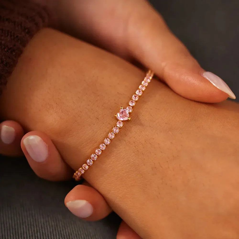Gold tennis bracelet with pink heart zirconia charm and pink stones