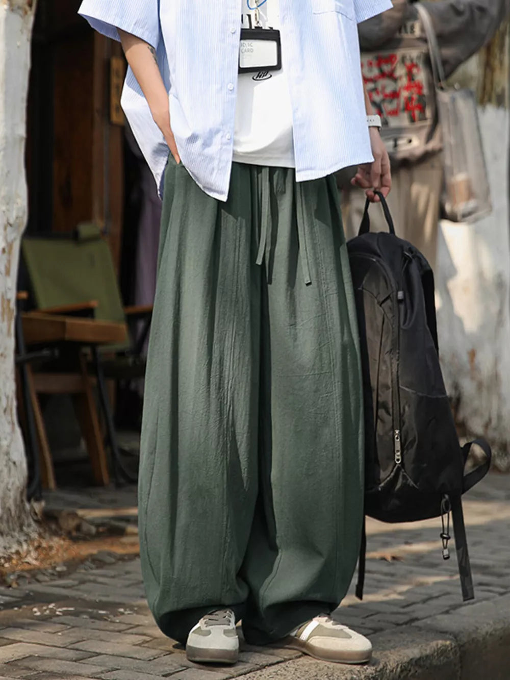 Plus size army green sweatpants with drawstring waist and wide leg.